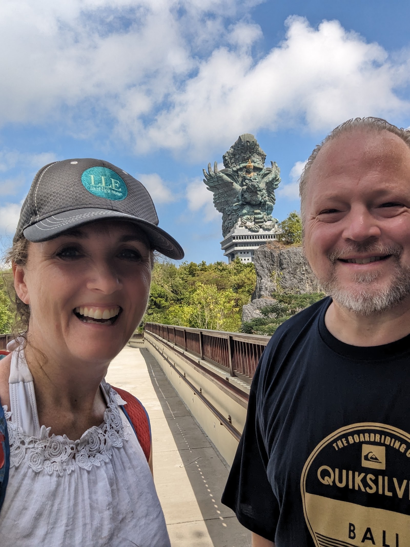 Jeff and Jillian in Bali, the Garuda Wisnu Kencana statue rising behind them